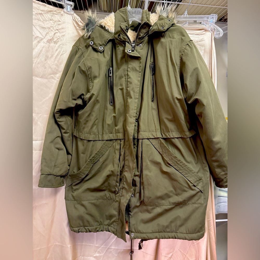 Olive green coat with fur hood. Plenty of pockets , zip front w button closure